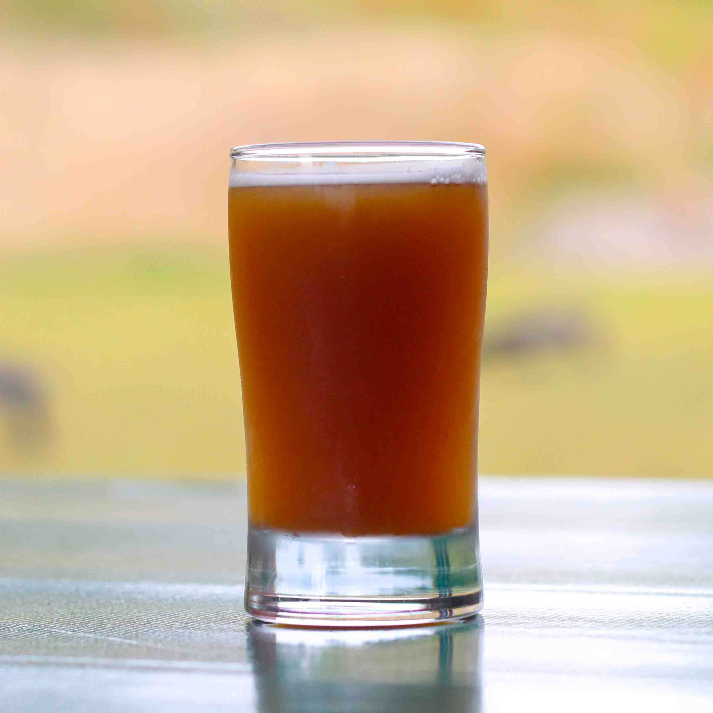 glass of beer on a picnic table